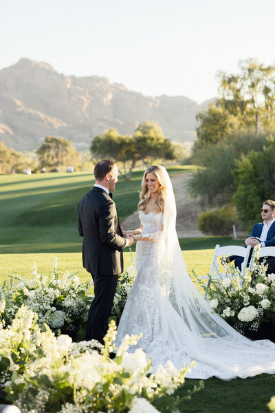 Bride and groom holding hands during wedding ceremony at Paradise Valley Country Club in Arizona