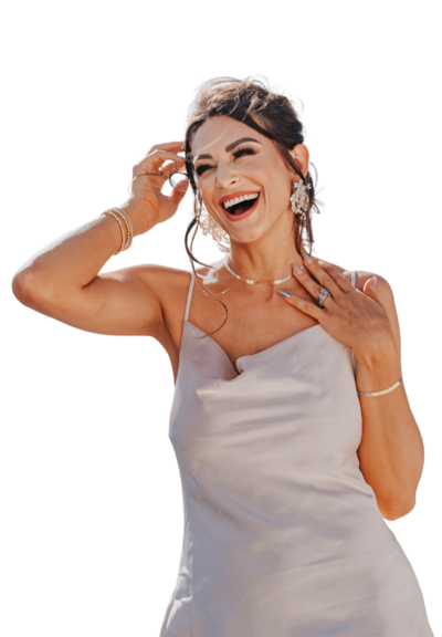 Cassandra posing and smiling in white dress