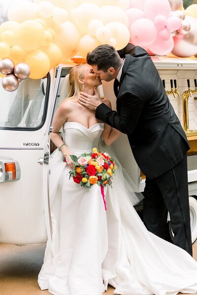 Wedding day couple kissing in front of Get Fizzy mobile bar at Atlanta Botanical Gardens in Atlanta Georgia