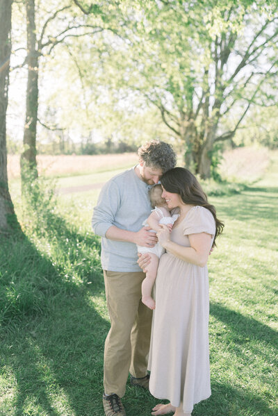 man women and baby hugging outside knoxville tennessee newborn photographer
