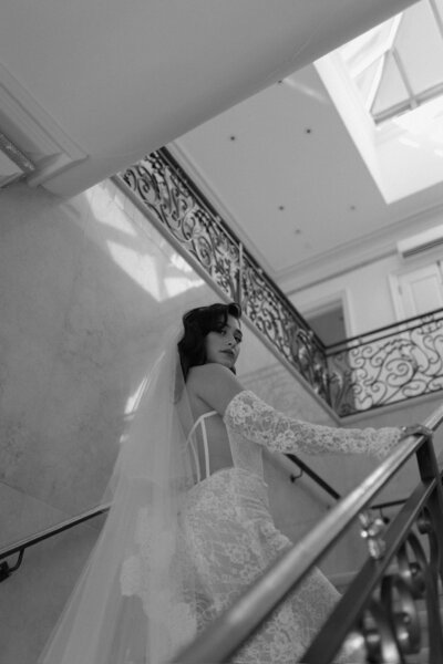 Bride looking down stairs at Raleigh wedding