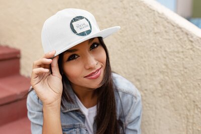 Girl wearing a white hat Mockup of photobooth branding on it