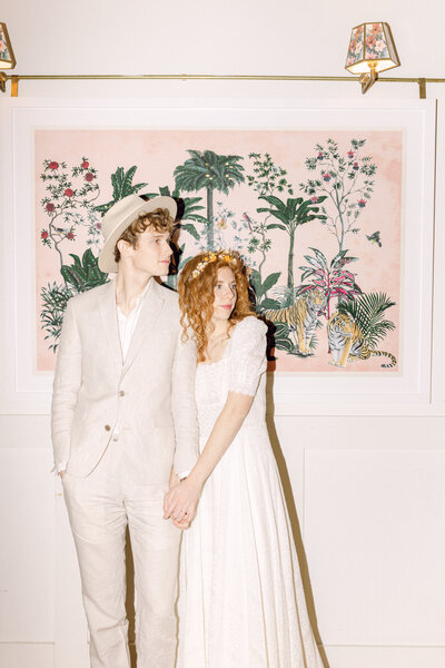 Bride and groom standing in front of a colorful mural at Common House Richmond, a modern wedding venue in Richmond, VA.
