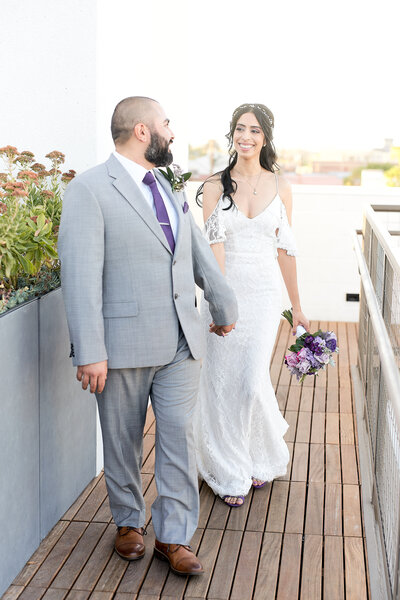 Husband and Life look longingly at each other as they walk along the Hart and Main's Garden Terrace Balcony