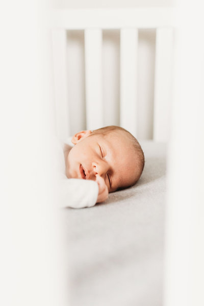 newborn sleeping in bed