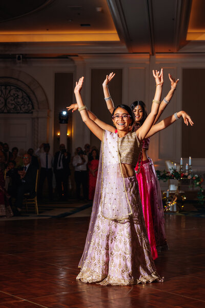A group of young dancers performing traditional Indian dance at a wedding reception.  Captured by an Orlando, Florida Indian Wedding Photographer.