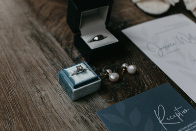 Close up flatlay image of wedding rings and earrings