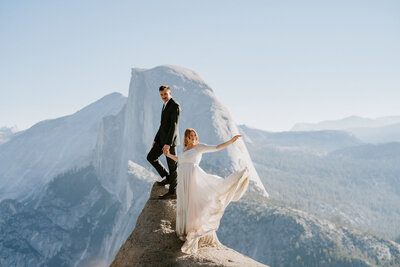couple pose at glacier point for sunrise elopement