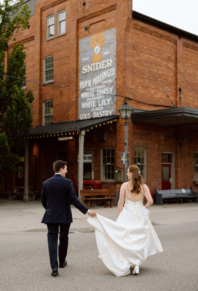 A bride and groom walking away from the camera during their wedding at Cellar52 in St. Jacob's, Ontario