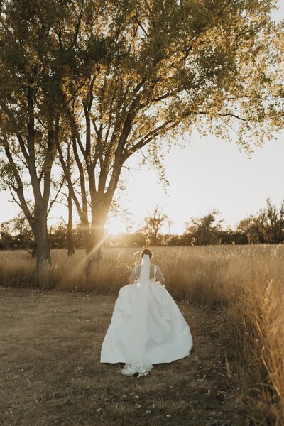 bride running away into the sunset