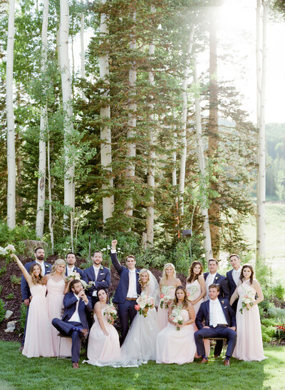 Newly married groom and bride click a picture with their best men and bridesmaids after a Forest Wedding.