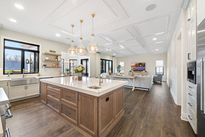 light brown wood cabinets and white counter overlooking living room