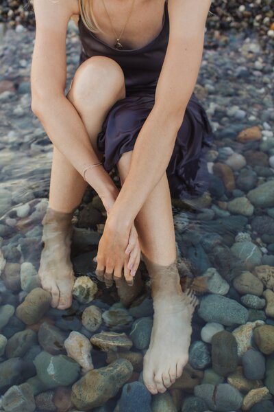 A woman sitting in the lake, immersed in the serene beauty of the water, reflecting tranquility and contemplation