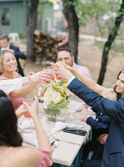 Wedding party cheers during reception at the wayback in texas