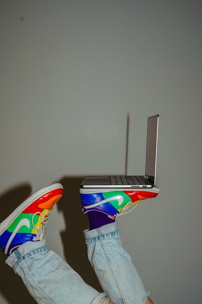 Laptop being held up on feet.