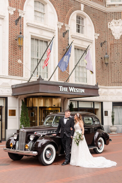 bride and groom with vintage car at the westin poinsett hotel wedding in greenville south carolina