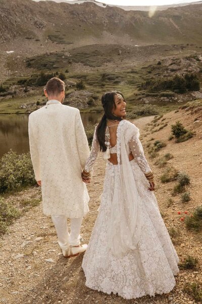 Summer time Colorado Elopement at Loveland pass with a couple wearing traditional South Asian Wedding Outfits including a lehenga
