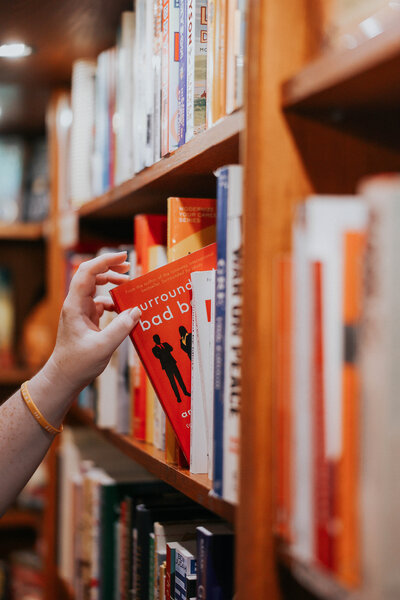 Jessie pulls a book off the shelf