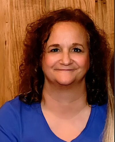 Natalie Jones in a blue jean suit smiling in a branding headshot