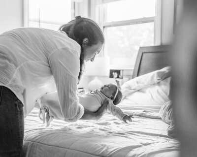 mom looks down on newborn baby girl