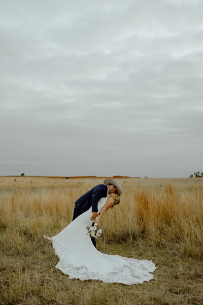bride and groom dip kissing