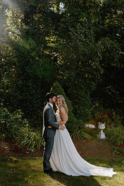 bride and groom embracing in sunlight