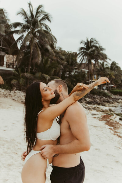 A couples photo session with tattoos and flowers.