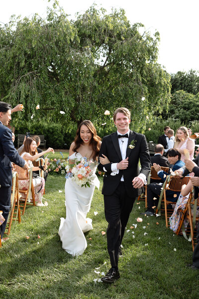 Couples processing down aisle at the market at grelen.