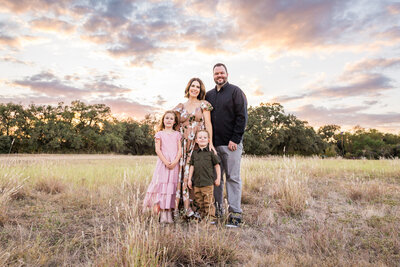 Family with two kids standing in a field, Austin Family Photographer, Tiffany Chapman Photography