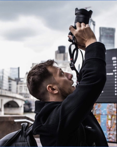 Photographer Peter Ali taking a photo in London