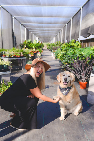 the founder of lavender landscape giving a happy puppy a handshake