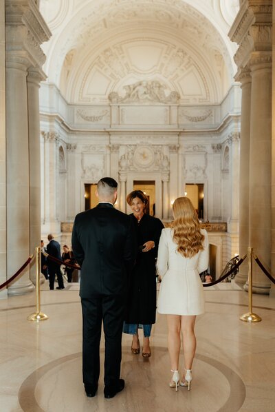 A stunning couple's portraits - bride and groom getting married at San Francisco's city hall. Luxury hair and makeup by Yana Beauty Studio.