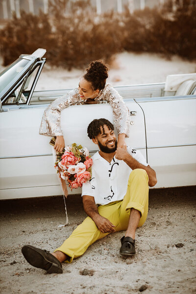 couple sits with car