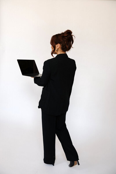 Silhouette of a person in heels and an oversized blazer