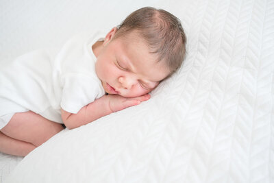 Newborn baby boy sleeping during lifestyle family newborn session in Brisbane.