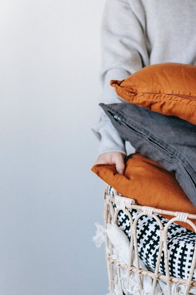 Neat stack of throw pillows in a basket