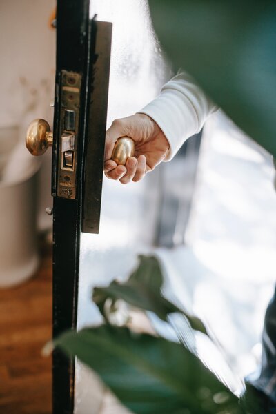 Photo by Charlotte May: https://www.pexels.com/photo/crop-person-opening-building-door-in-sunlight-5825395/