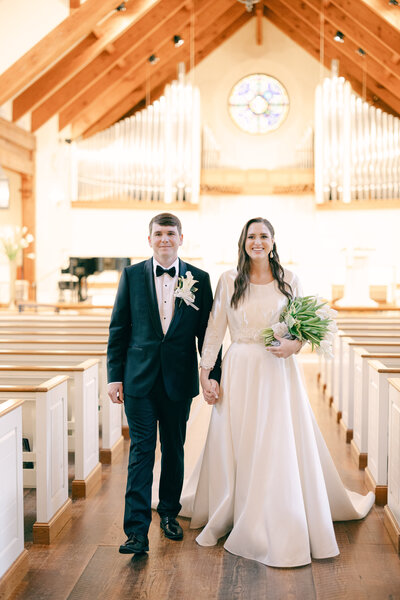 a bride and groom standing in a church on their wedding day