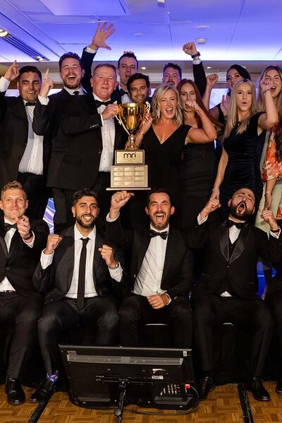 Corporate awards night in Perth with team celebrating a trophy win, perfect for DJ and event entertainment.