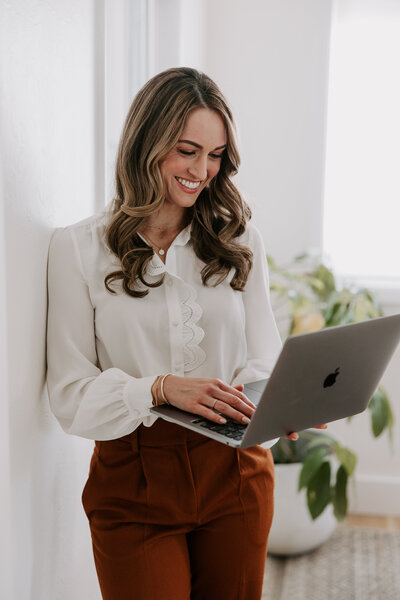 Website copywriter Erika Fitzgerald holding a laptop