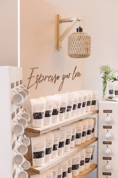 ‘Espresso Your Love’ wedding seating chart display with mugs, espresso bean favors, and guest table assignments designed by Cove Mill Design Co.