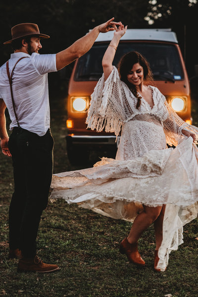 Couples Photographer, Man and woman twirling in front of a van