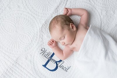 newborn photography savannah of sleeping newborn on monogram blanket