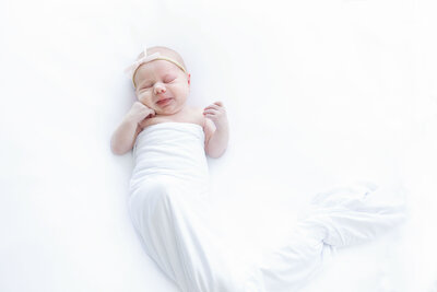 Sweet Newborn dressed in all white sleeping and smiling with NH Newborn Photographer Kathleen Jablonski