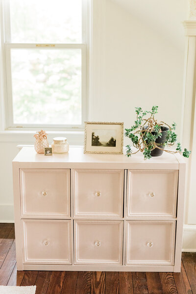 A storage cubby that's been transformed into a diy piece of furniture with drawers and crystal knobs.