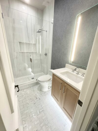 A luxurious bathroom renovation in Frisco, showcasing elegant materials and expert craftsmanship.