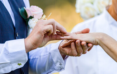 Man putting wedding ring on new wife