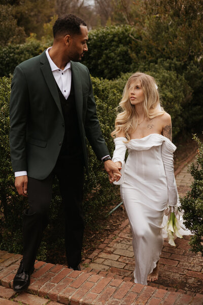 documentary style wedding photos of the bride and groom walking away