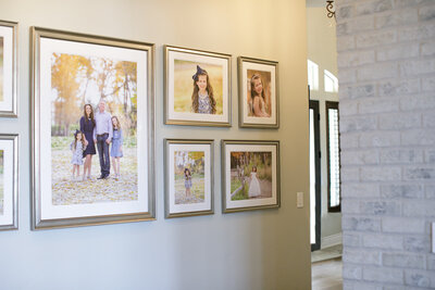 Wall gallery of family photos in Eagle, Idaho home.