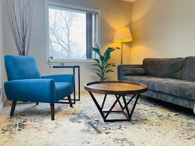 A calming therapy room in Ottawa, offering Brainspotting, Hypnotherapy, and Health Coaching sessions in a peaceful, supportive environment